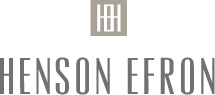 grey square with abstract white lines in a geometrical arrangement above grey sans serif text that reads "henson efron" logo
